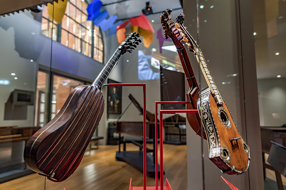 Guitars on display in glass cabinets in the RCM Museum